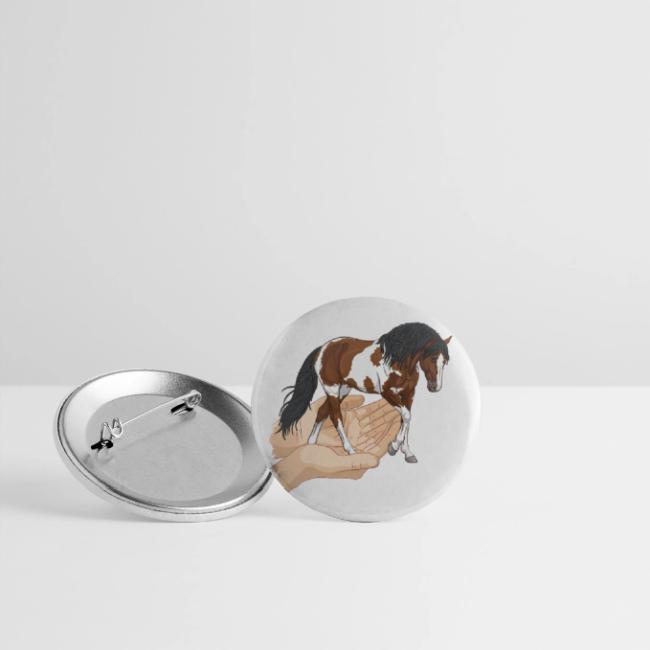 Un cheval pie qui sort de deux mains jointes